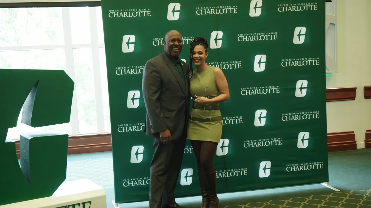 Shayauna Newsom posing next to Kevin Bailey with their Assessment Champion award.